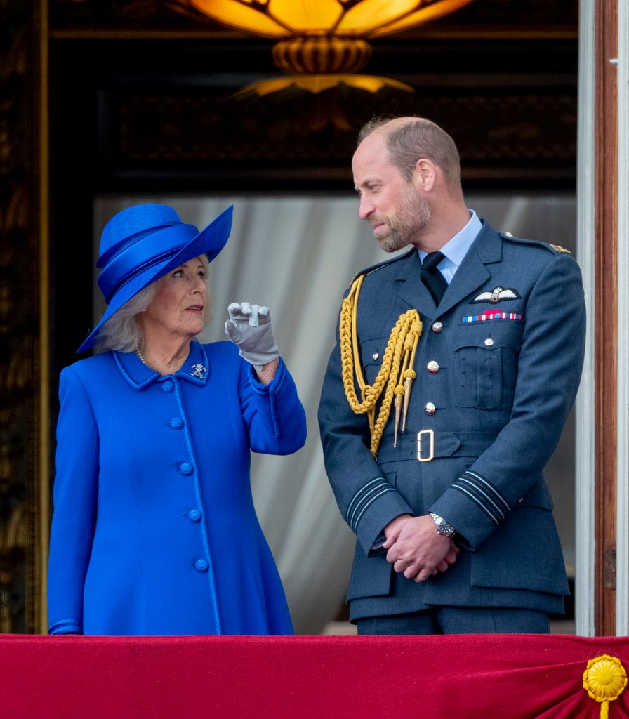 Queen Camilla talking to Prince William on palace balcony