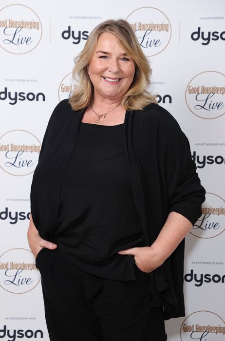 Fern Britton smiling in a black outfit on the red carpet