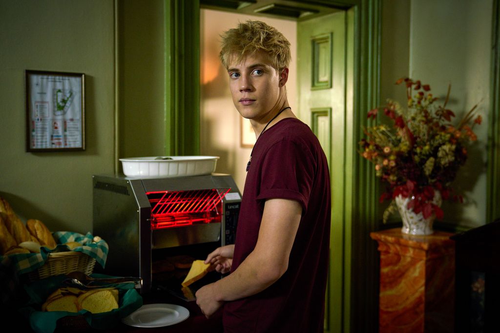 teenage boy using toaster