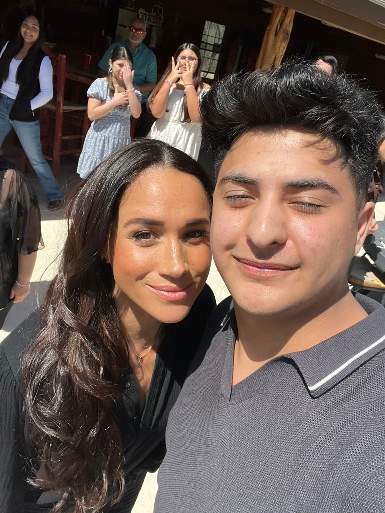 Meghan Markle taking a selfie with a male