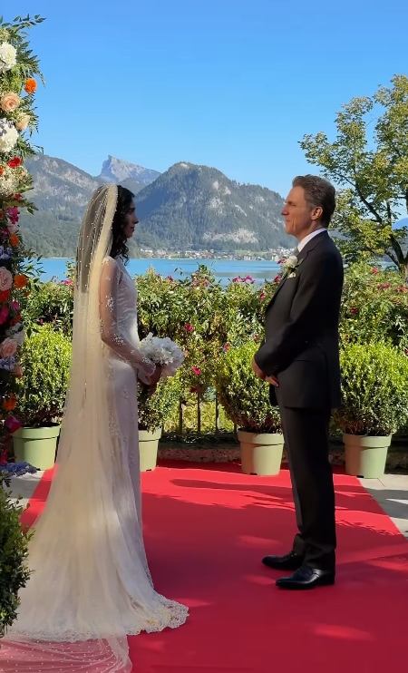 bride and groom facing eachother with mountain backdrop