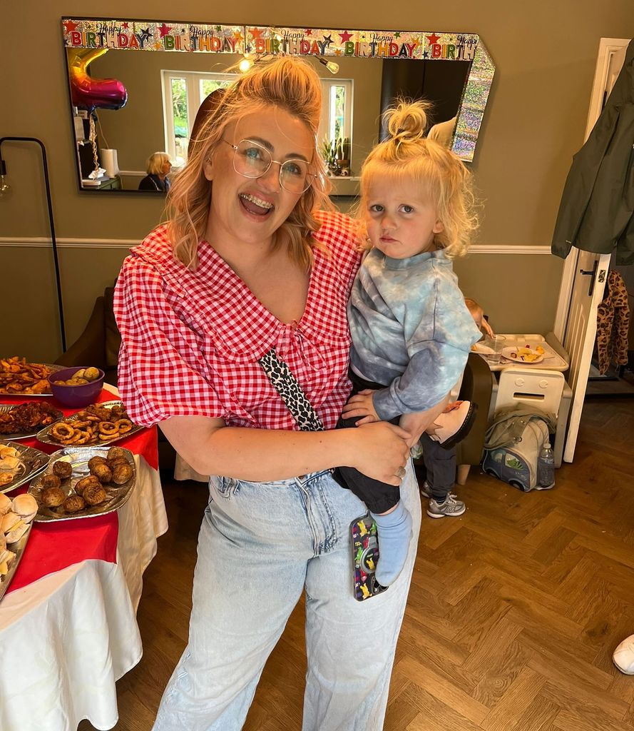 mother holding son on hip 