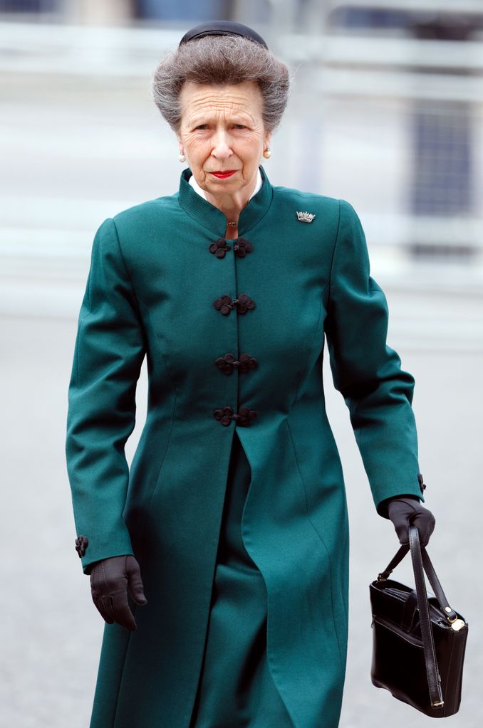 Princess Anne in a green coat and hat holding a handbag