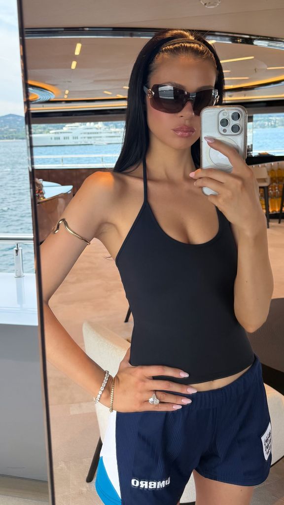 Nicola peltz in black tank top and football shorts