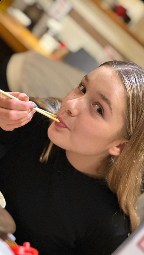 Harper Beckham eating with chopsticks in Japan