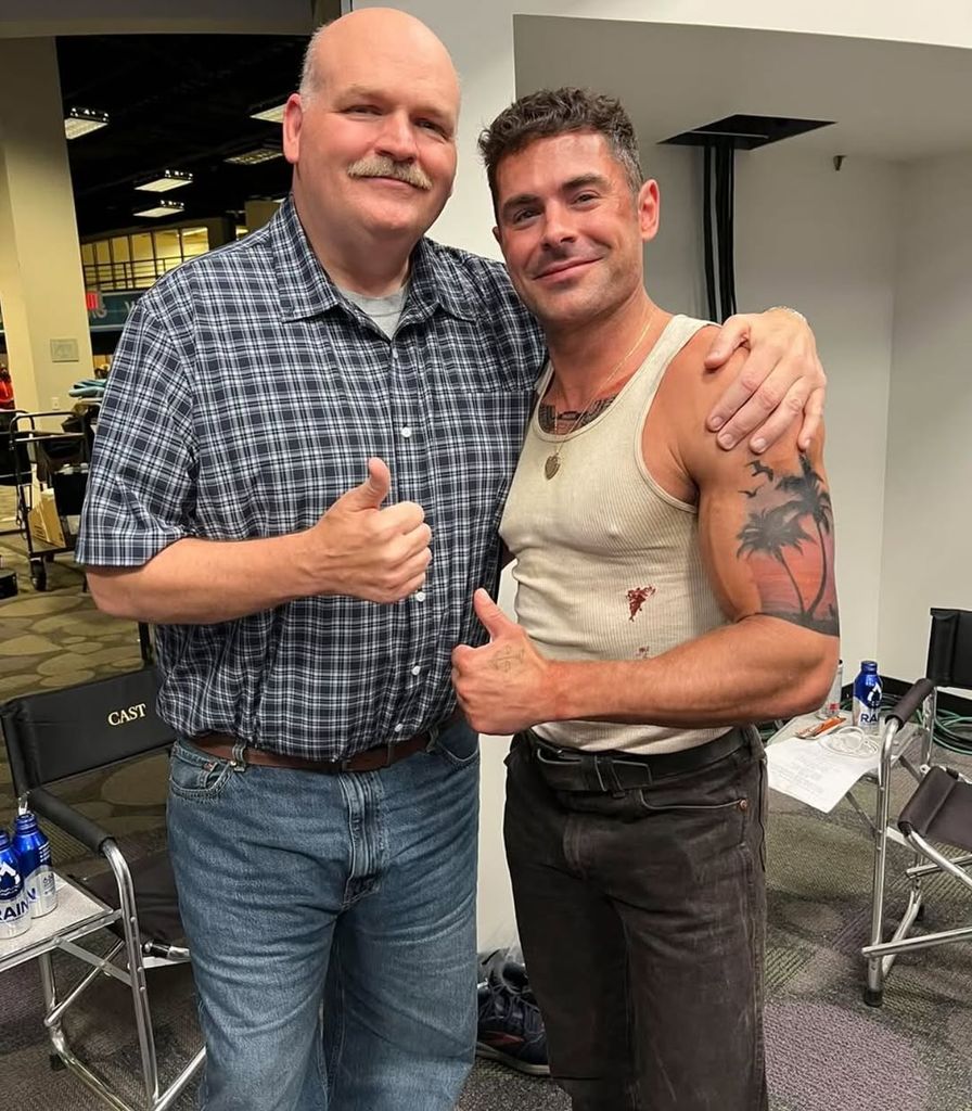 Zac posing with crew member on set