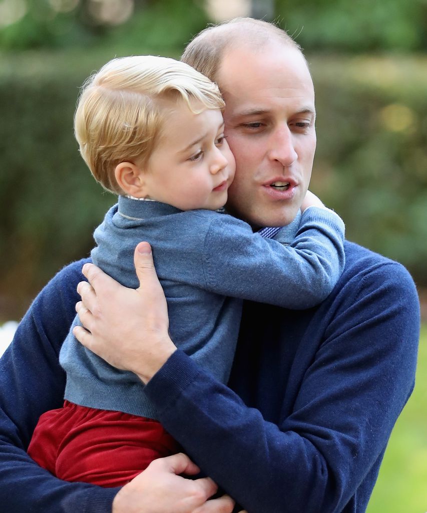 Prince George hugs his dad Prince William at a children's party for Military families during the Royal Tour of Canada