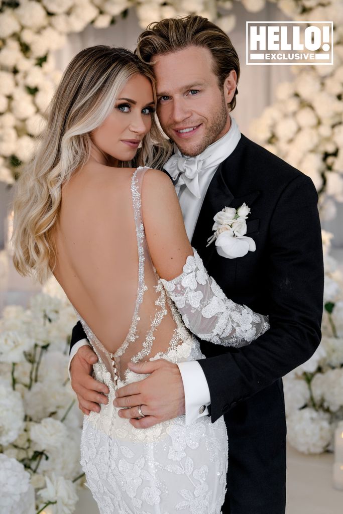 Amelia Tank showed off the low of her wedding dress as she hugged Olly Murs