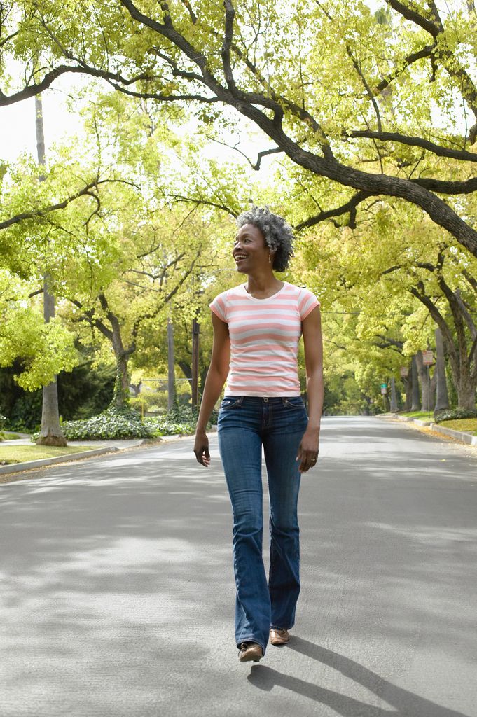 women with grey hair walking in park
