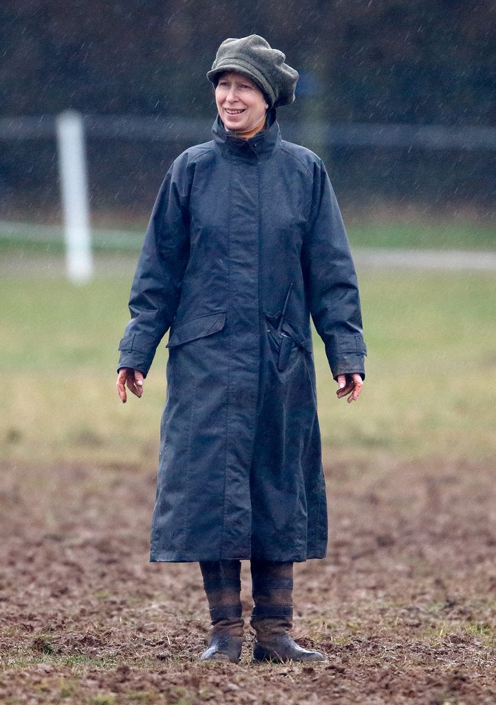 Princess Anne, Princess Royal stands in the rain in a muddy field as she attends the Gatcombe Horse Trials at Gatcombe Park