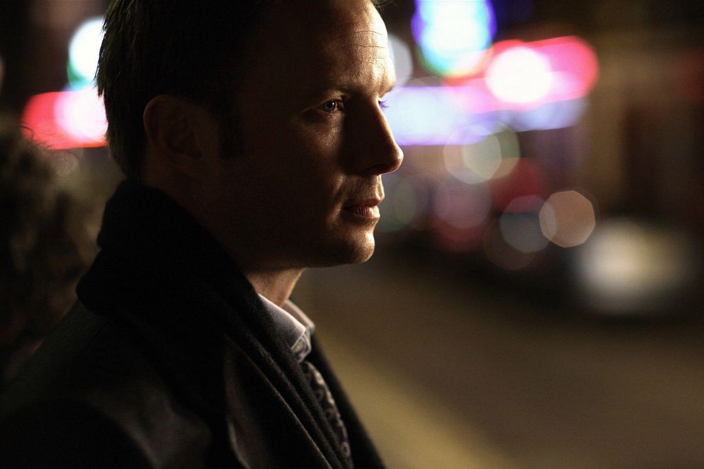 man standing in dark street