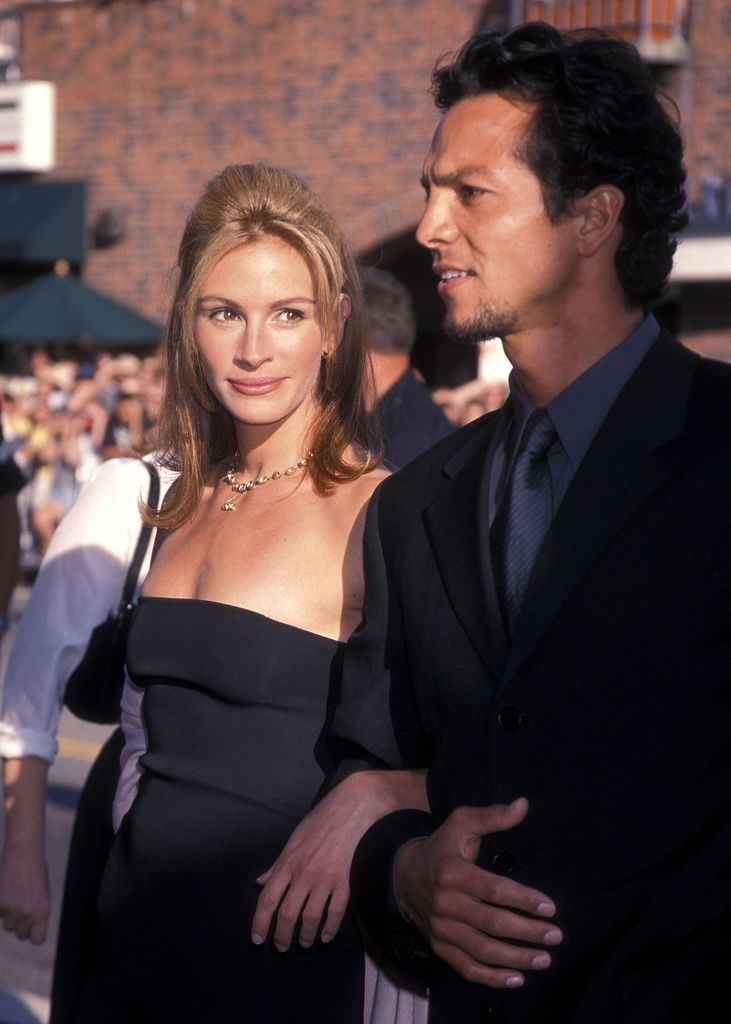 Julia Roberts and actor Benjamin Bratt attend the 'Runaway Bride' Westwood Premiere on July 25, 1999 at Mann National Theatre in Westwood, California