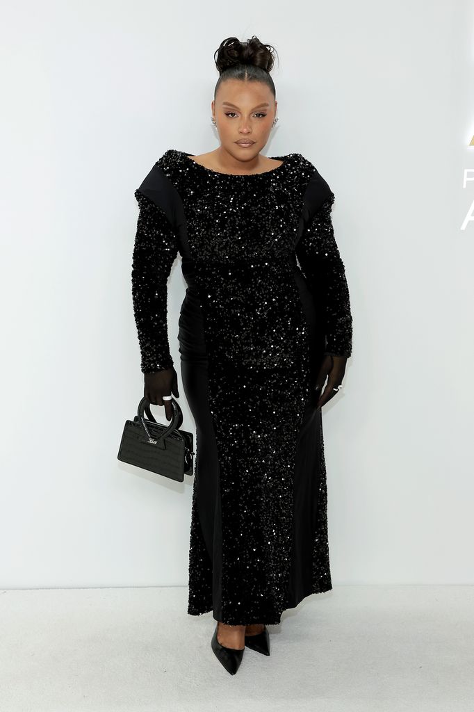 Paloma Elsesser in a black sequin gown with padded shoulders, gloves and a structured handbag at the 2022 CFDA Fashion Awards.