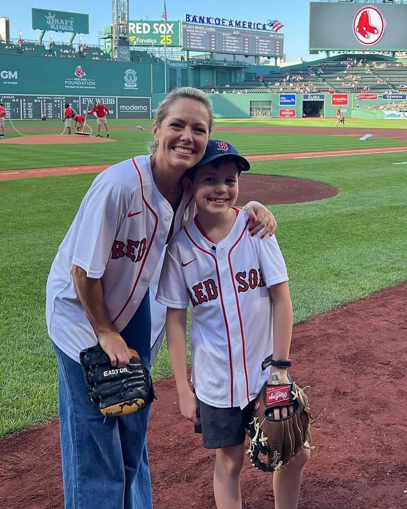 Dylan dreyer and her son Calvin posing at the Boston Red Sox game