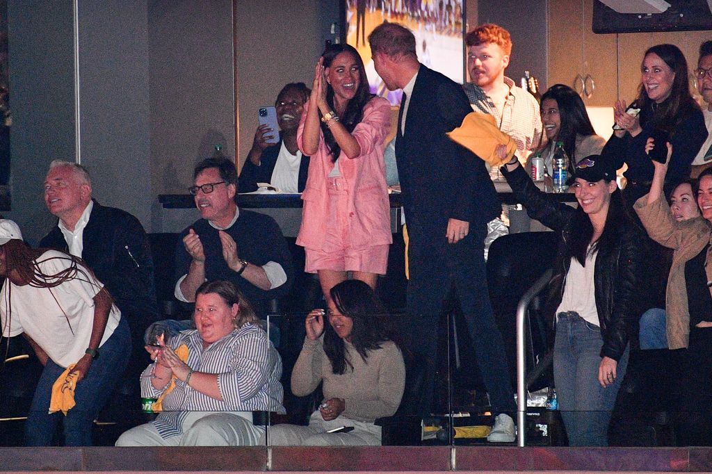 Prince Harry and Meghan Markle applauding