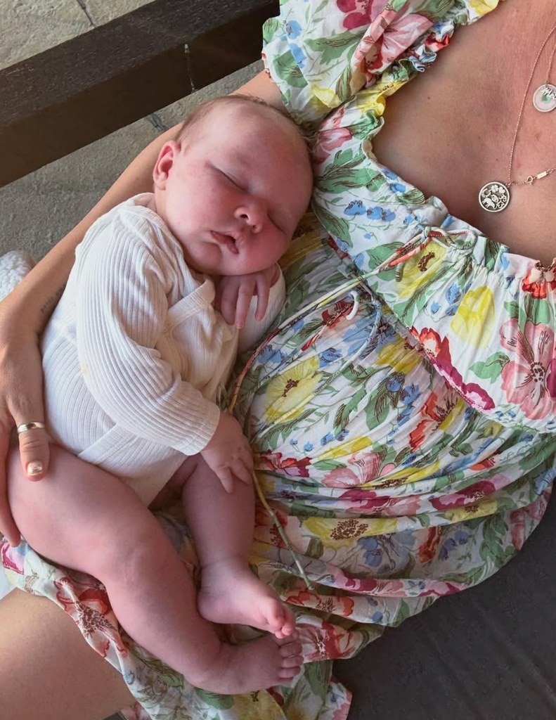Photo shared by Eric Christian Olsen's wife Sarah Wright of her snuggling with their newborn, their fourth child, daughter Ocean Rain