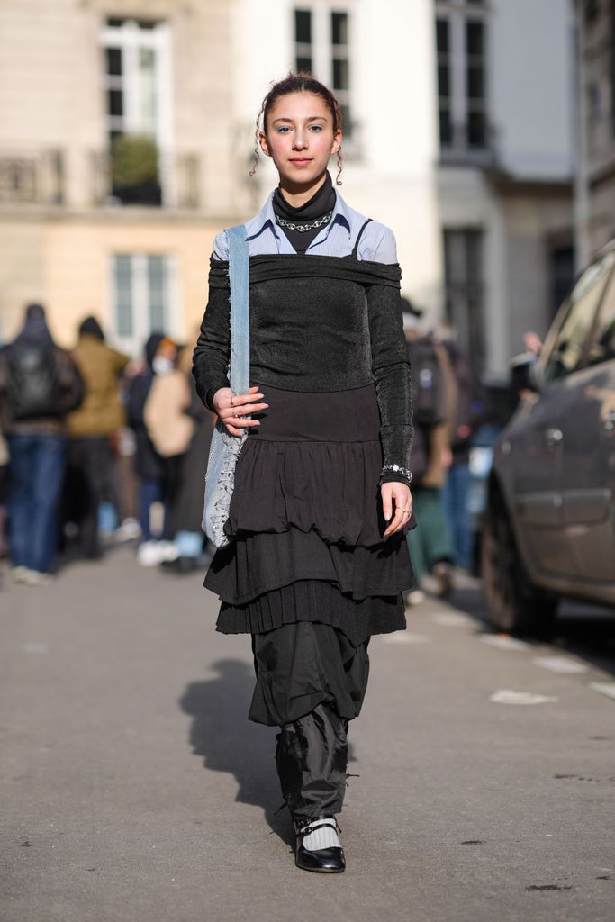 Caroline Takrarit teams her black turtleneck with a light blue shirt and a dress on top, outside the Valentino AW24 show in Paris. 