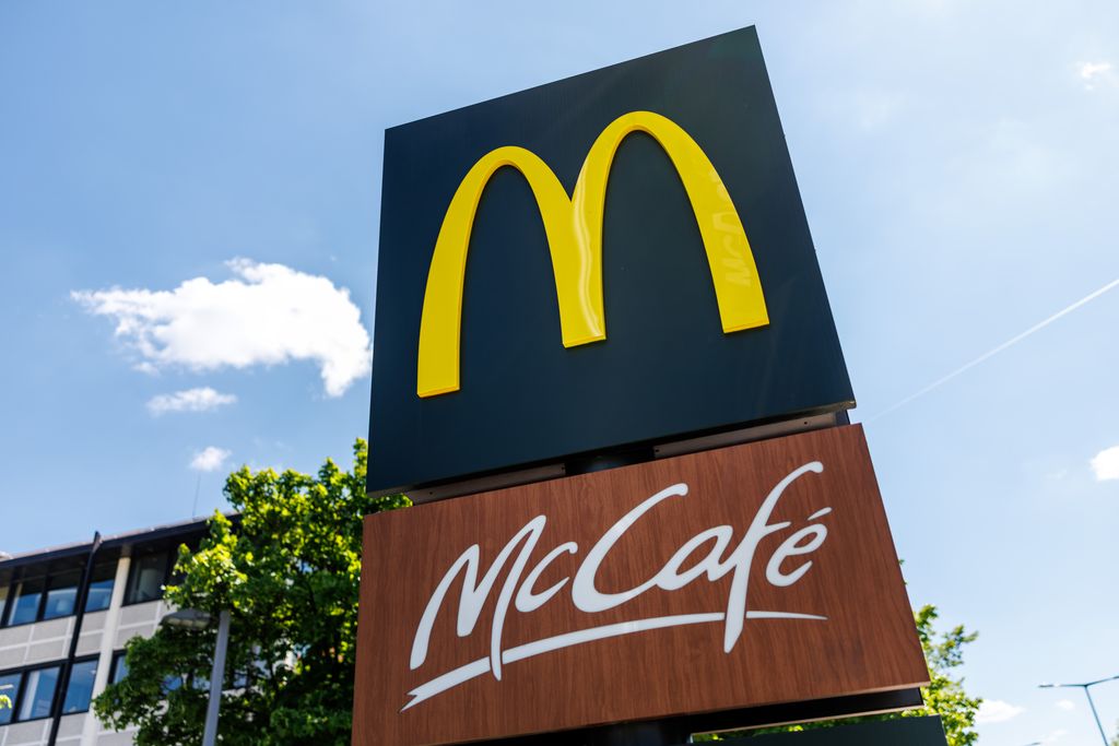 The illuminated lettering and logo of McDonald's and McCafe 