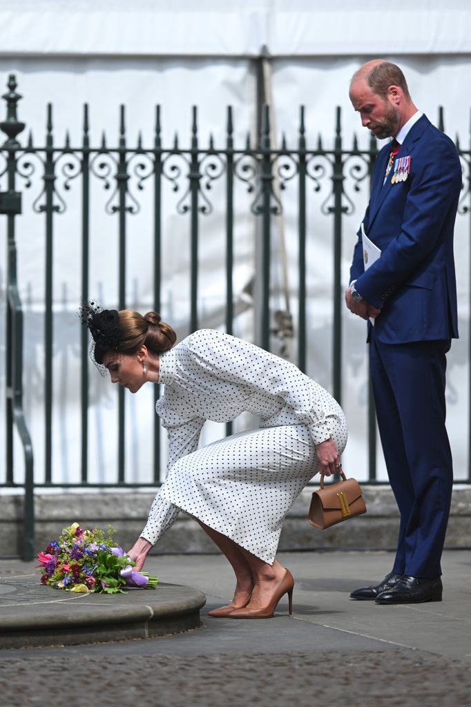 The Princess of Wales lays flowers on the Innocent Victims Memorial with Prince William