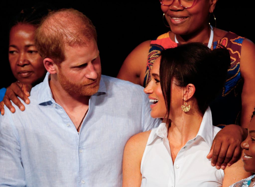 Prince Harry and Meghan Markle look at each other