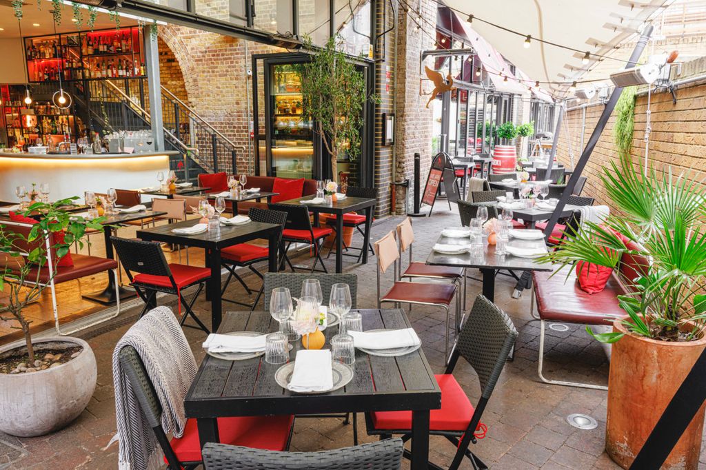 outdoor terrace with tables, chair and plants