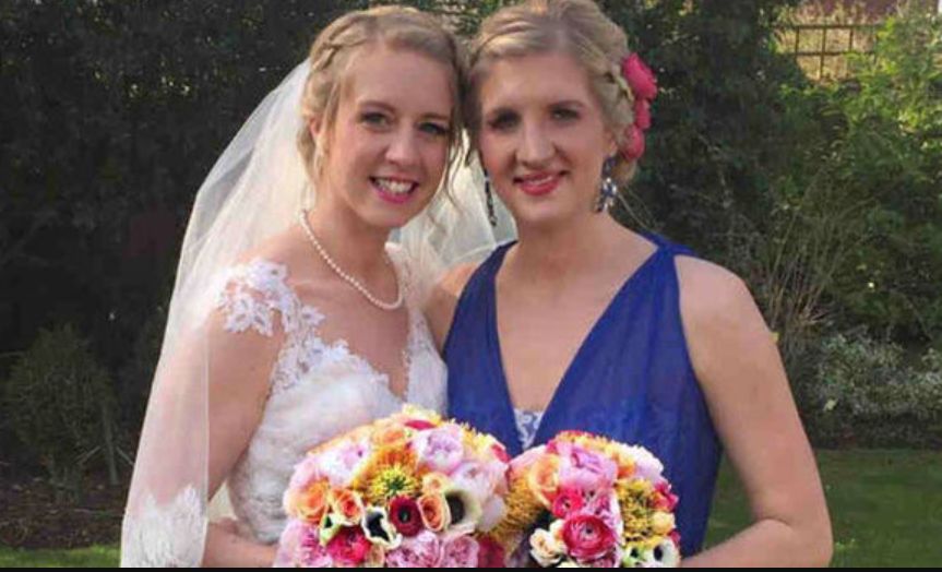 Chloe Adlington in a wedding dress with Rebecca Adlington in a blue dress - both hold a bouquet of flowers