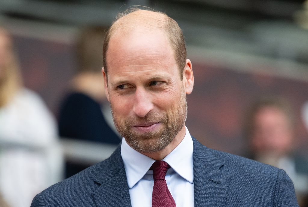 Prince William with a smug expression at a rugby match