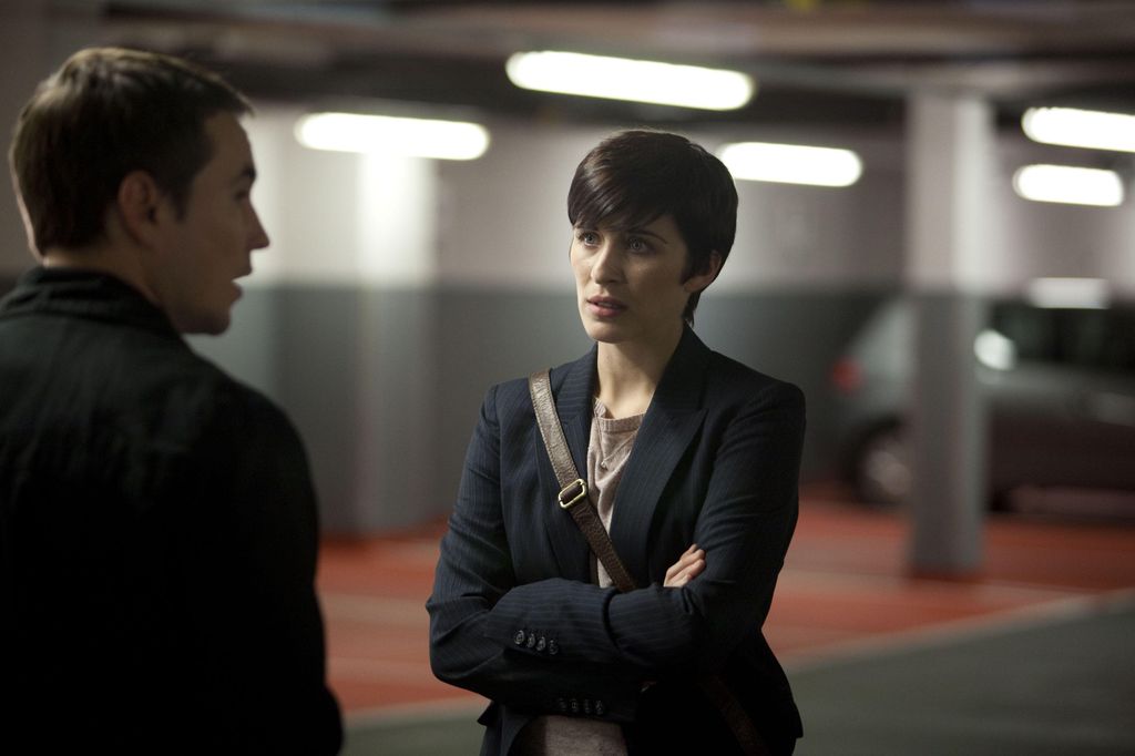 woman looking at man in underground carpark