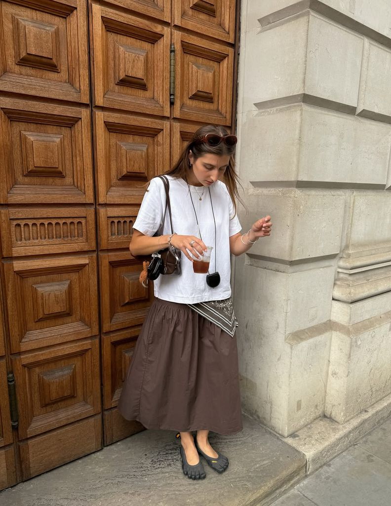 Poppy Almond in brown skirt