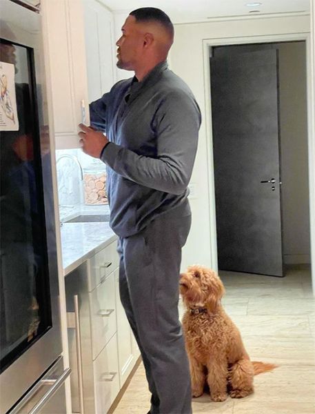 Michael Strahan and dog in kitchen