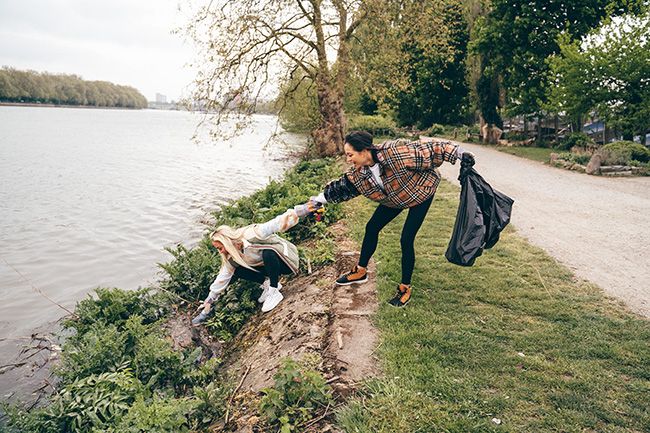 Katya Jones and Aimee Fuller litter pick by river
