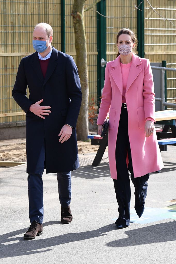 kate middleton wearing a pink coat with large pockets