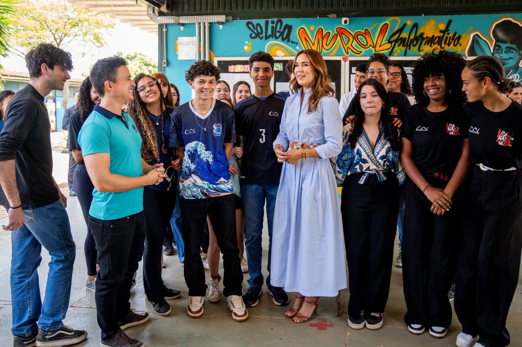 Queen Mary among people in striped shirt dress