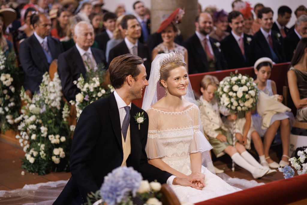 bride and groom seated in church