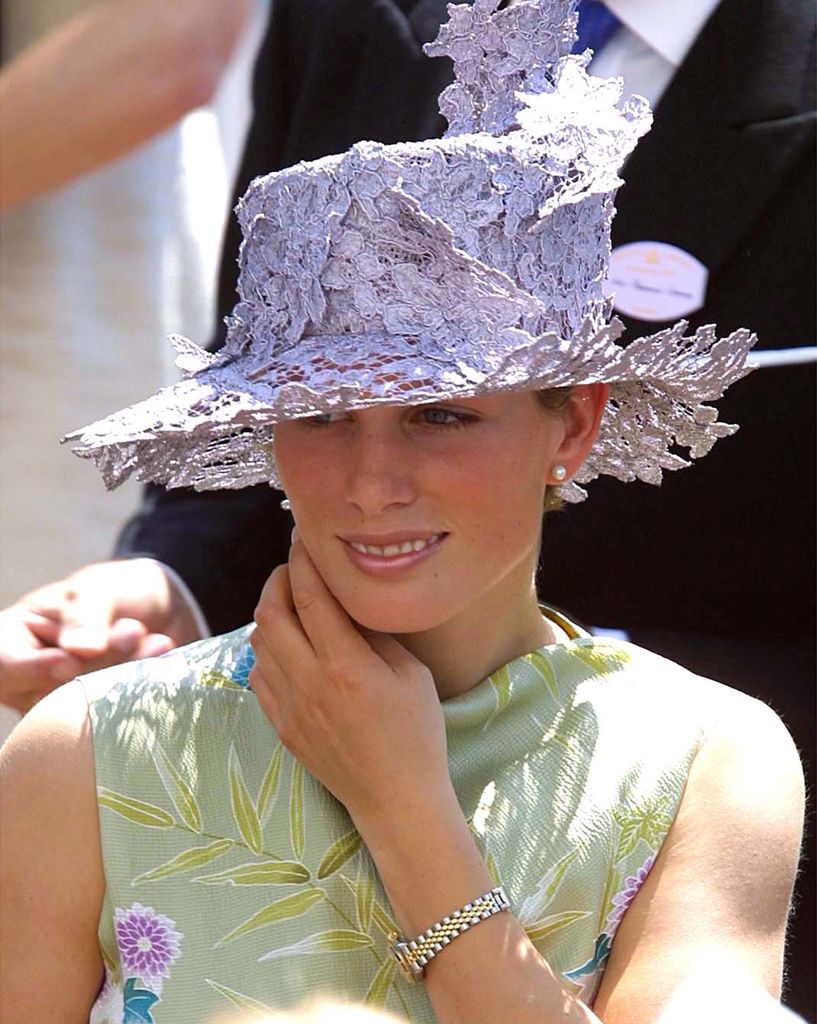 Zara Tindall wears a lace hat , pearl earrings and cowl-neck green dress