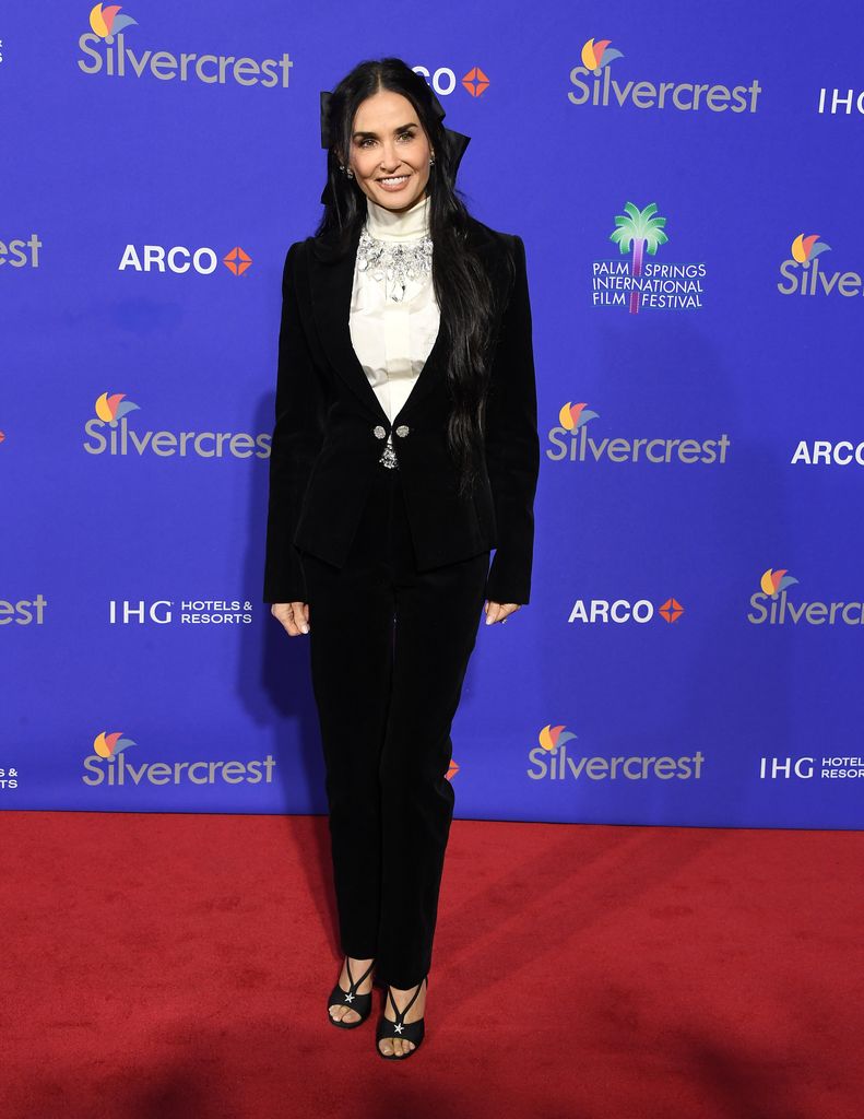 Demi Moore on red carpet in black suit