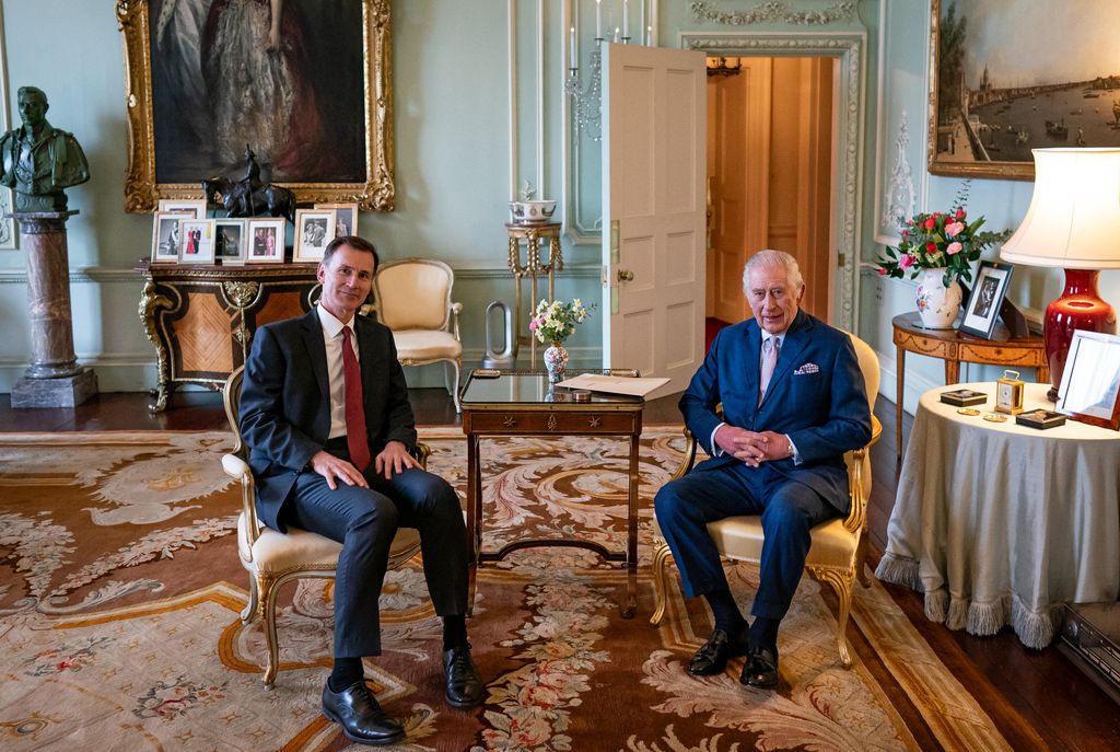 King Charles III and Britain's Chancellor of the Exchequer Jeremy Hunt, pose for a photograph during their meeting in the private audience room at Buckingham Palace