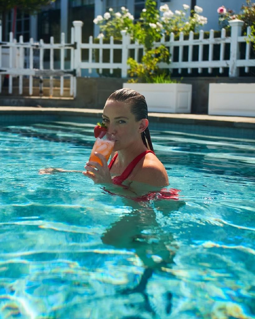 Kate Hudson drinking a cocktail in the swimming pool
