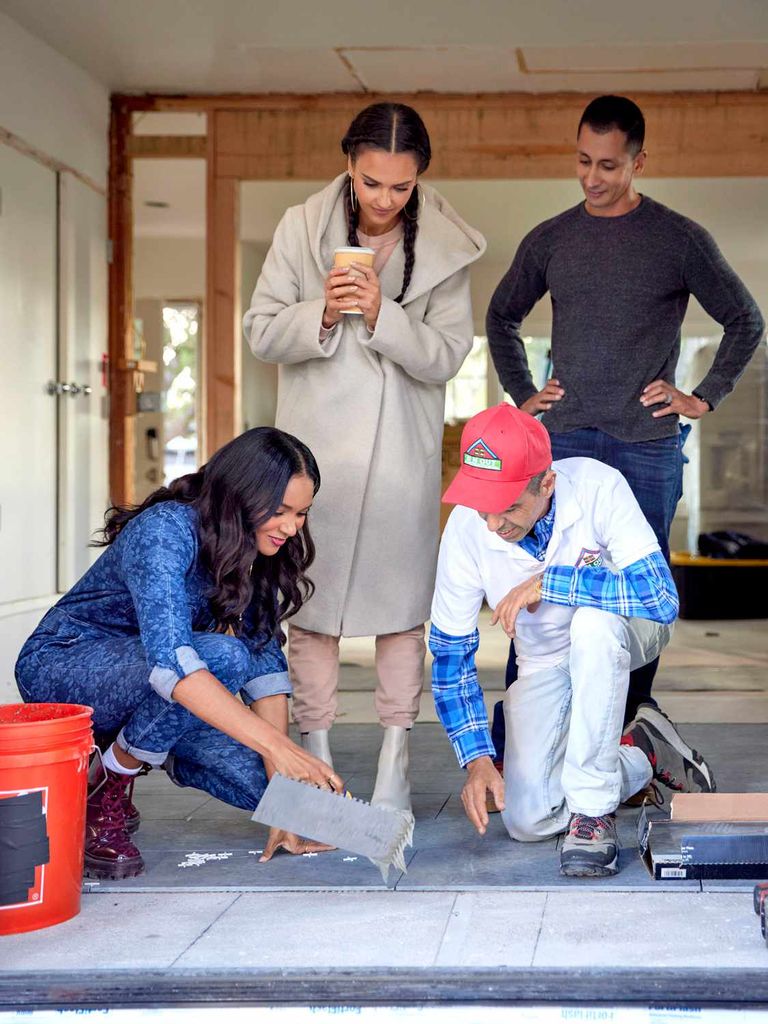 Jessica Alba watches as Lizzy Mathis and builders cement a patio