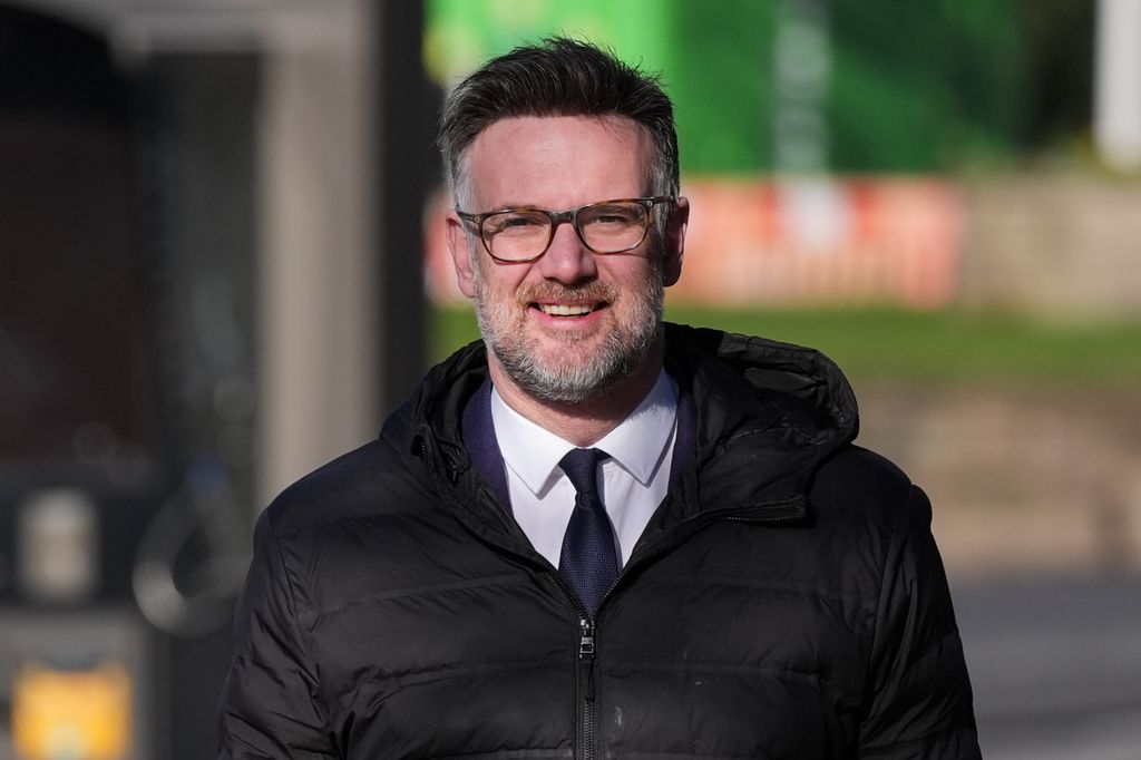 man in suit and glasses wearing coat
