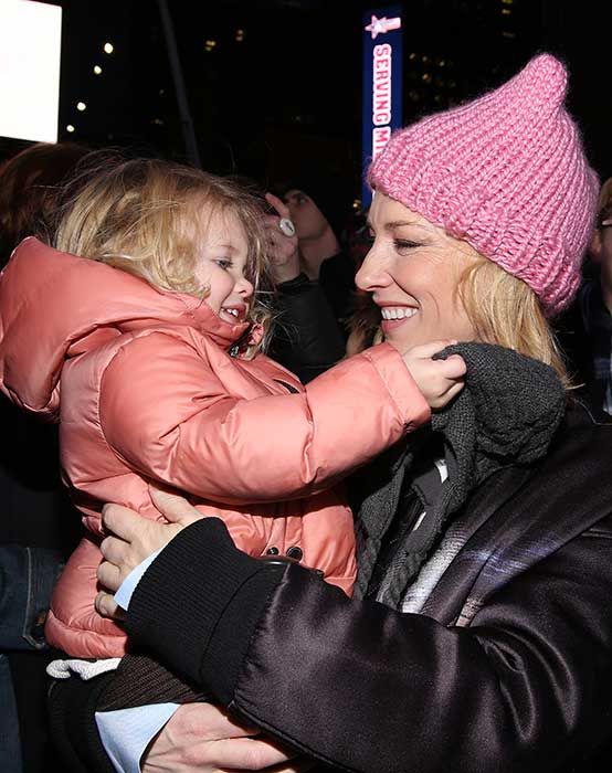 Cate Blanchett smiling and holding her daughter Edith