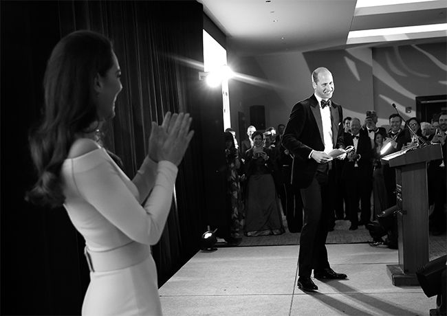Kate Middleton applauding Prince William as he talks to the press