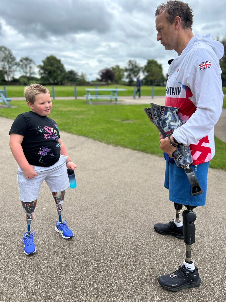 young boy chatting to Paralympian 