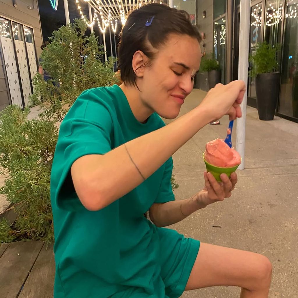 Tallulah with hair pulled back and eating ice slushy
