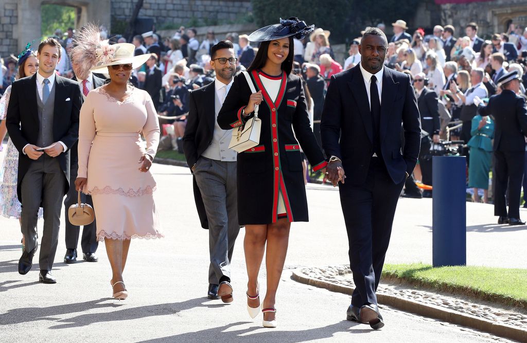 Idris Elba holding hands with wife Sabrina with Oprah Winfrey in the background