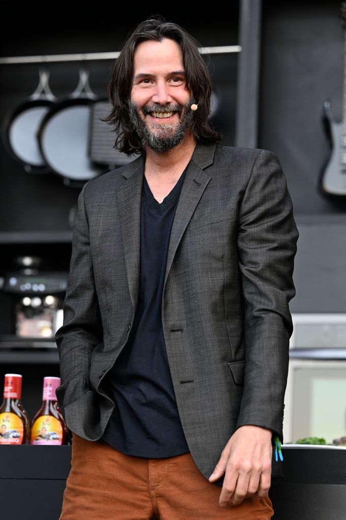 Keanu Reeves smiling on stage