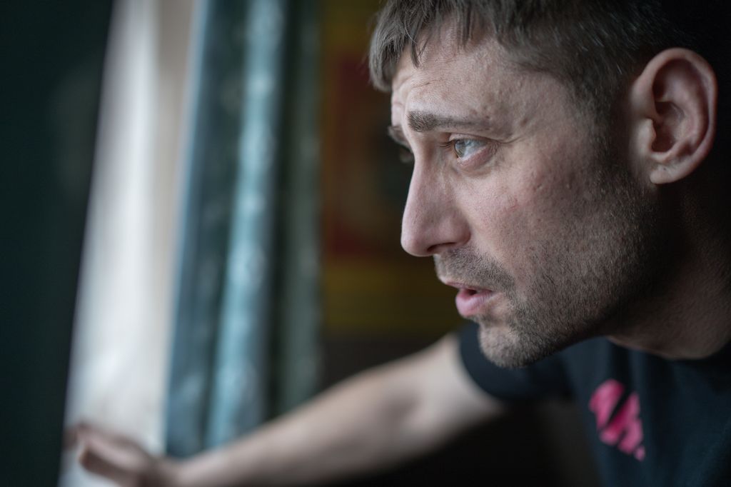 close-up of man looking out of window