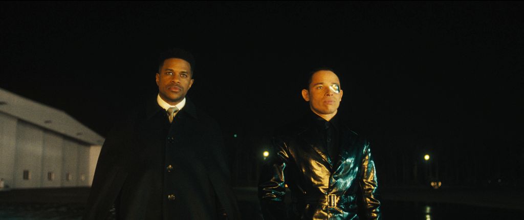 two men outdoors in dark 