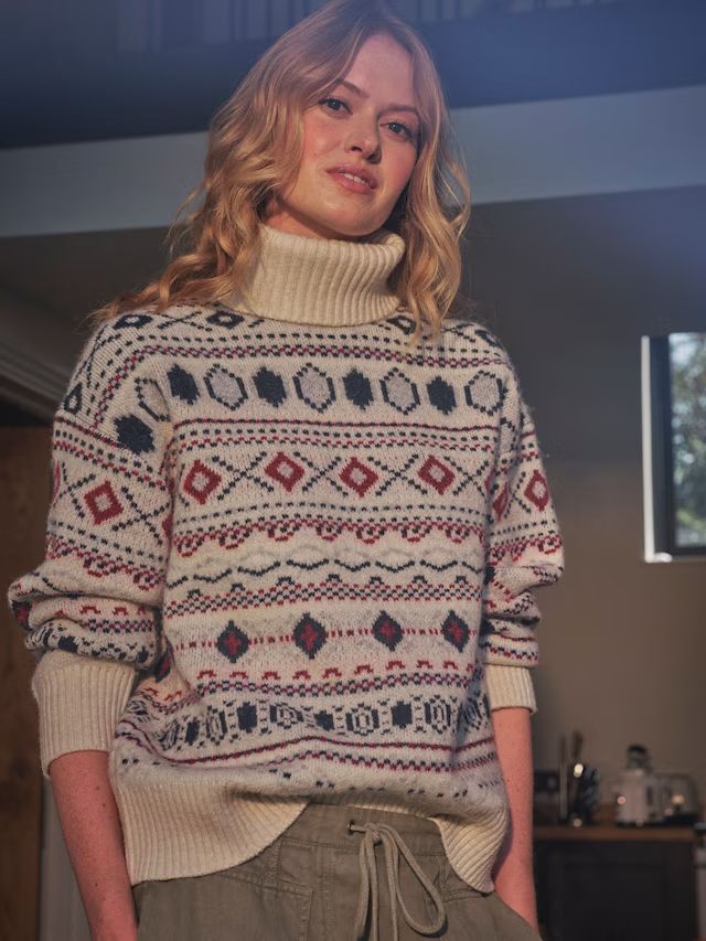 model wearing roll neck jumper with fairisle print