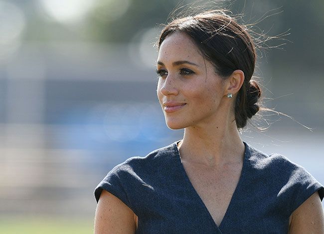 The Duchess of Sussex in a denim dress at the Sentebale Polo Cup in 2018 